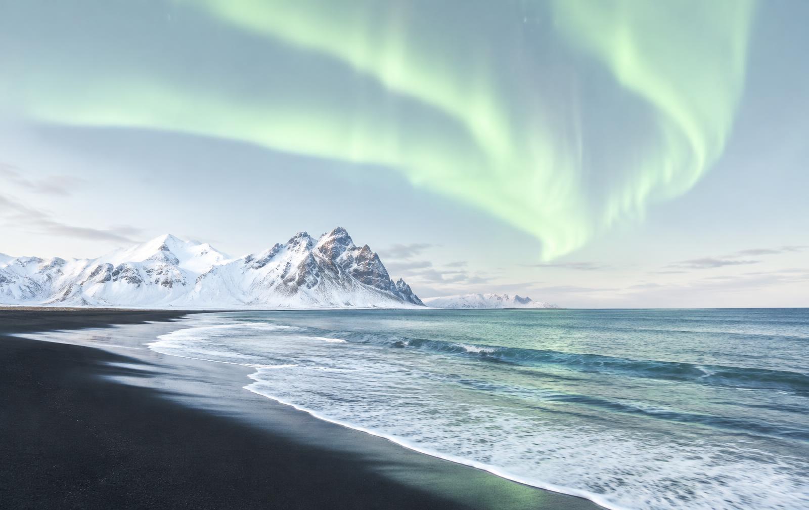 Black-sand Icelandic coastline under the northern lights, Auroracoin Foundation